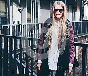 Blond fashion blogger posing in fashionable clothes in the city. Streetstyle. Outdoor.