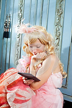 Blond fashion princess woman reading ebook tablet