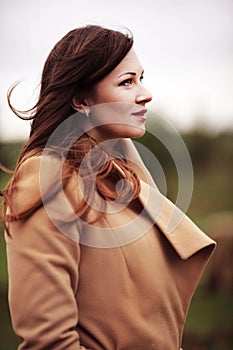 Blond fashion woman walking outdoor against an autumn landscape