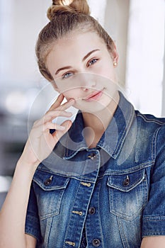 Blond female dressed in a denim jacket.