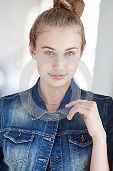 Blond female dressed in a denim jacket.