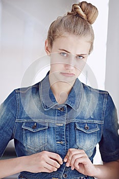 Blond female dressed in a denim jacket.