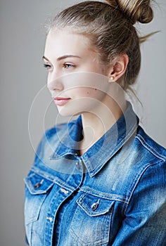 Blond female dressed in a denim jacket.