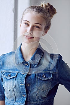 Blond female dressed in a denim jacket.