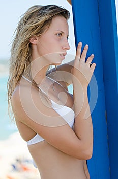 Blond female model with slim and attractive body in bikini