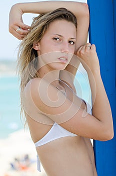 Blond female model with slim and attractive body in bikini