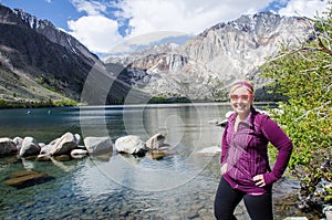 Blond female poses by Convict Lake in the springtime, located off of US-395, near Mammoth Lakes California in the eastern Sierra