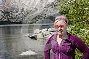 Blond female poses by Convict Lake in the springtime, located off of US-395, near Mammoth Lakes California in the eastern Sierra