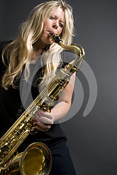 blond female saxophone player musician