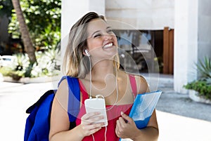 Blond female student listening to music