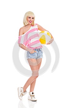 Blond girl with a beach ball