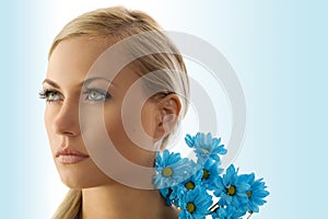 Blond girl with blue daisy