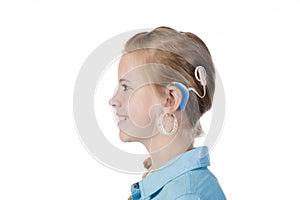 Blond girl with cochlear implant