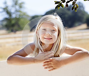 Blond Girl on Farm Fence