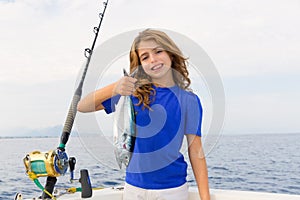 Blond girl fishing bluefin tuna trolling sea