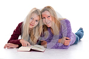 Blond girl and her mother using tablet PC