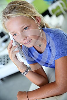 Blond girl at home talking on the phone