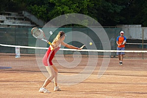 Blond girl playing tennis