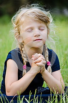 Blond girl praying