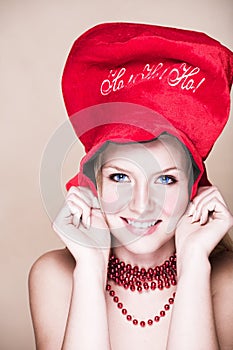 Blond girl in red necklace and hat