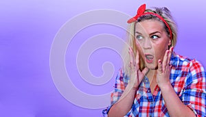 Blond girl in retro fashion style looking suprised to left empty space