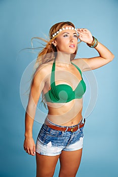 Blond girl with short jeans on blue