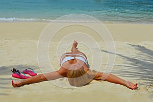 Blond girl suntanning on the beach