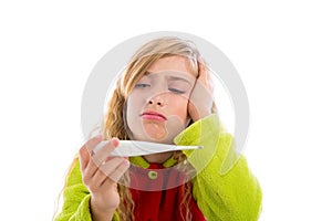 Blond girl with thermometer and flu cold in pyjama