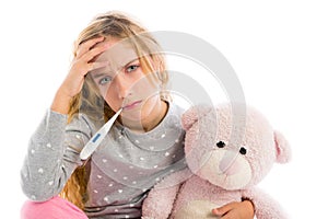 Blond girl with thermometer and flu cold in pyjama