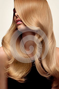 Blond hair. Portrait of beautiful Blonde with Long Wavy Hair. Hi