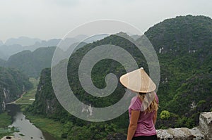 Blond hair woman and breathtaking panoramic view over the Tam Coc Valley