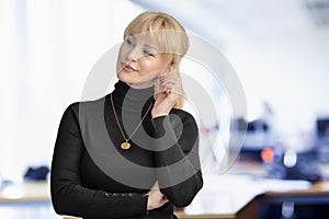 Blond haired businesswoman standing at the office