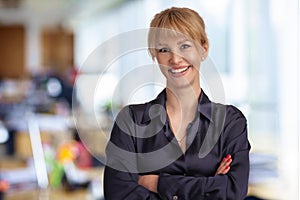 Blond haired businesswoman standing at the office