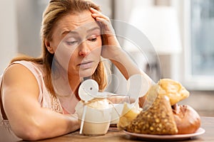 Blond-haired woman having allergy to gluten and dairy