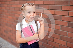 Blond happy smiling little girl excited laugh hands in mouth.