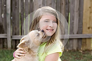 Blond kid girl with chihuahua pet dog playing