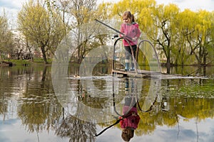 Blond kid girl fishing tuna little tunny happy with trolling catch on boat deck