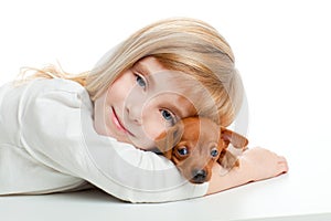 Blond kid girl with mini pinscher pet mascot dog