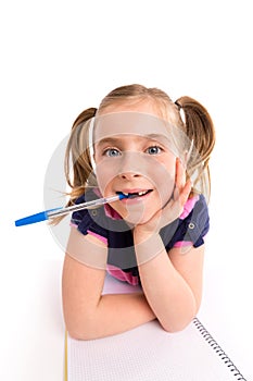 Blond kid girl student with spiral notebook in desk