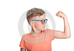 Blond kid in glasses showing his hand biceps muscles isolated on white background. Smart and sport child boy showing