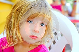 Blond little girl looking camera blue eyes