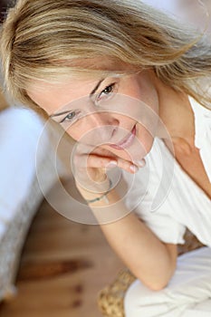 Blond mature woman sitting and thinking