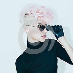 blond model in vintage glasses with stylish haircut. fashion photo