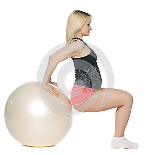 Blond pregnant woman doing pilates.