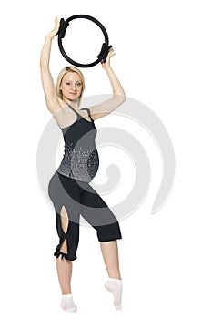 Blond pregnant woman doing pilates.