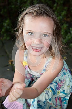 a blond pretty child girl outdoor garden