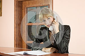Blond receptionist at phone