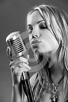 Blond singing with vintage microphone