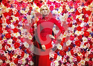 Blond slim woman over the flower wall