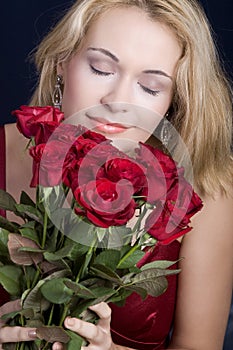 Blond smelling roses